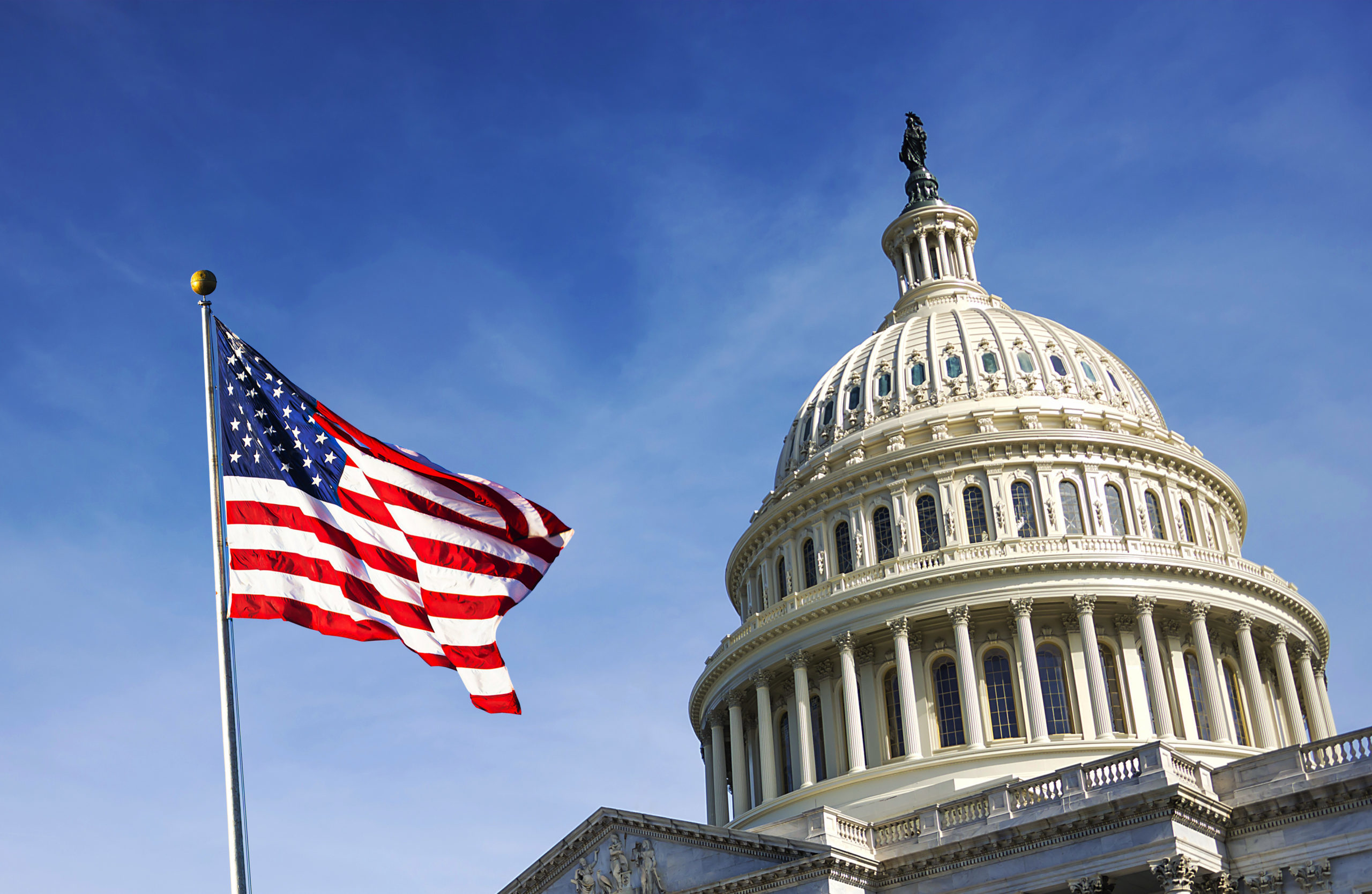 American flag waving with the Capitol Hill