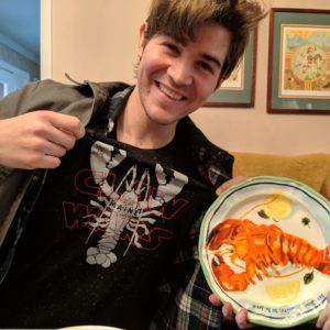 Taylor Bird wearing a Star Wars lobster shirt and holding a lobster plate.